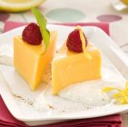 Citrus pudding with fresh raspberries — Stock Photo