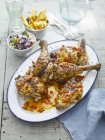 Piripiri chicken with coleslaw  on white plate over wooden surface — Stock Photo