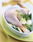 Raw leg of turkey with vegetables — Stock Photo