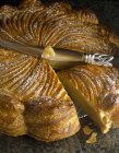 Closeup view of cut Pithivier pie and knife — Stock Photo