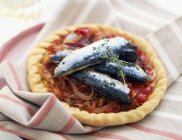 Pissaladire with fresh sardines on cloth — Stock Photo