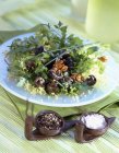 Walnut and snail salad on plate — Stock Photo