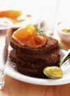 Salmon gravlax on bread toasts — Stock Photo