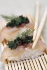 Nigiri sushi with tuna and herbs — Stock Photo
