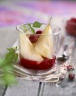 Closeup view of pears with raspberry Coulis sauce — Stock Photo