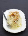 Sauerkraut with haddock on white plate with fork — Stock Photo