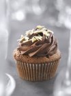 Chocolate cupcake on grey — Stock Photo