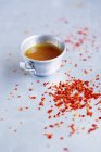 Closeup view of chilli flakes and chilli sauce in metal cup — Stock Photo