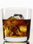 Glass of whiskey with ice cubes — Stock Photo