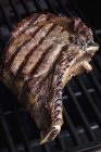 T-bone steak on grill — Stock Photo