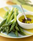 Green asparagus with french dressing — Stock Photo