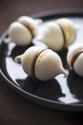 Chocolate meringues on dark plate — Stock Photo