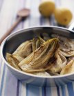 Braised chicory in frying pan — Stock Photo