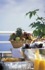 Денний вид на кошик з фруктами на столі біля моря — стокове фото