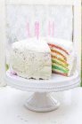 Rainbow cake with candles — Stock Photo
