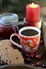 Closeup view of coffee with cookies and burning candle — Stock Photo