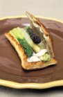 Asparagus in puff pastry on brown plate — Stock Photo