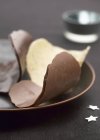 Chocolate tuiles on plate — Stock Photo