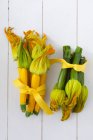 Yellow and green courgettes with flowers — Stock Photo