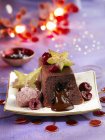 Closeup view of chocolate Moelleux cake with star fruit and candied cherries — Stock Photo