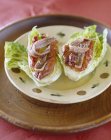 Closeup view of lettuce heart with marinated peppers and anchovies — Stock Photo