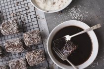 Top view of Lamingtons and chocolate icing — Stock Photo