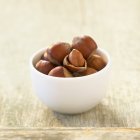 Small bowl of hazelnuts — Stock Photo