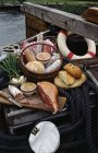 Cooked meats on boat — Stock Photo