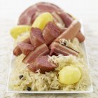 Choucroute on white plate — Stock Photo