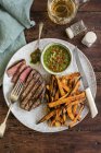 Fillet steak with sweet potato fries — Stock Photo