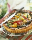 Closeup view of Provenal tart with knife on cooling wire rack — Stock Photo