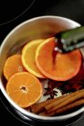 Mulled wine with sliced oranges — Stock Photo