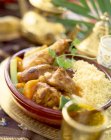 Couscous with chicken served in bowl — Stock Photo