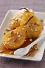 Closeup view of braised pears with spices and nuts — Stock Photo
