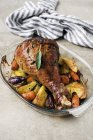 Roast leg of turkey with vegetables in glass dish — Stock Photo