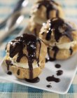 Profiteroles on plate and on table — Stock Photo