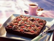Fresh baked chocolate brownie with raspberries — Stock Photo