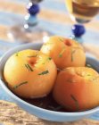 Closeup view of yellow peaches with wine and herb — Stock Photo