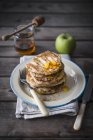 Stack of apple pancakes with honey — Stock Photo