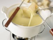 Cheese fondue in bowl — Stock Photo