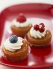 Closeup view of rum Babas with cream and berries — Stock Photo