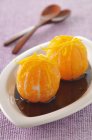 Mandarins in caramel sauce — Stock Photo