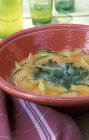 Closeup view of cold melon soup with basil — Stock Photo