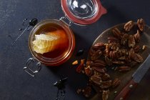 Honey and pecan nuts — Stock Photo