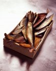Crate of smoked fish — Stock Photo