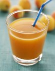 Apricot juice in glass — Stock Photo
