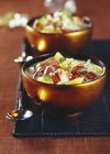 Closeup view of lobster and orange soups in bowls — Stock Photo