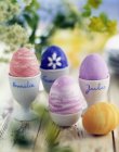 Closeup view of painted eggs with signed eggcups — Stock Photo