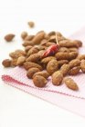 Almonds with a chilli pepper — Stock Photo