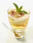 Closeup view of peach and muscat soup with mint leaves — Stock Photo